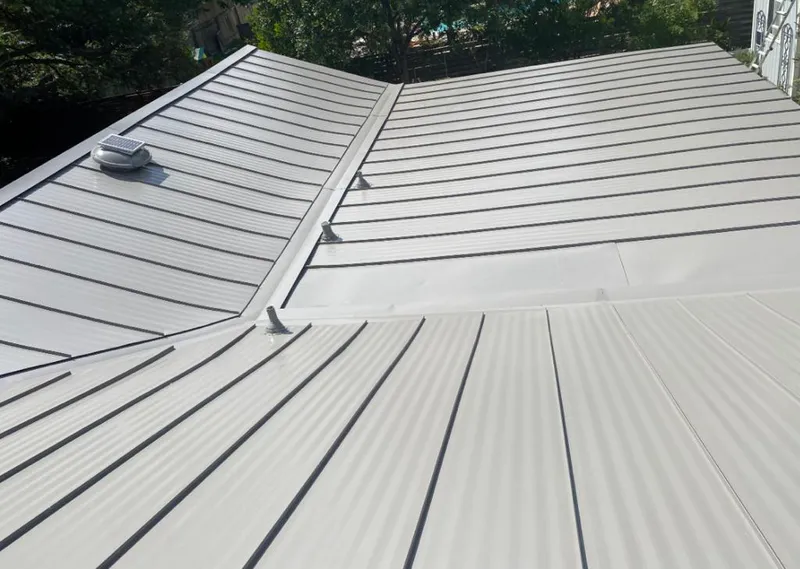 Solar attic fan installed on a metal roof for Roof Ventilation in Lisbon